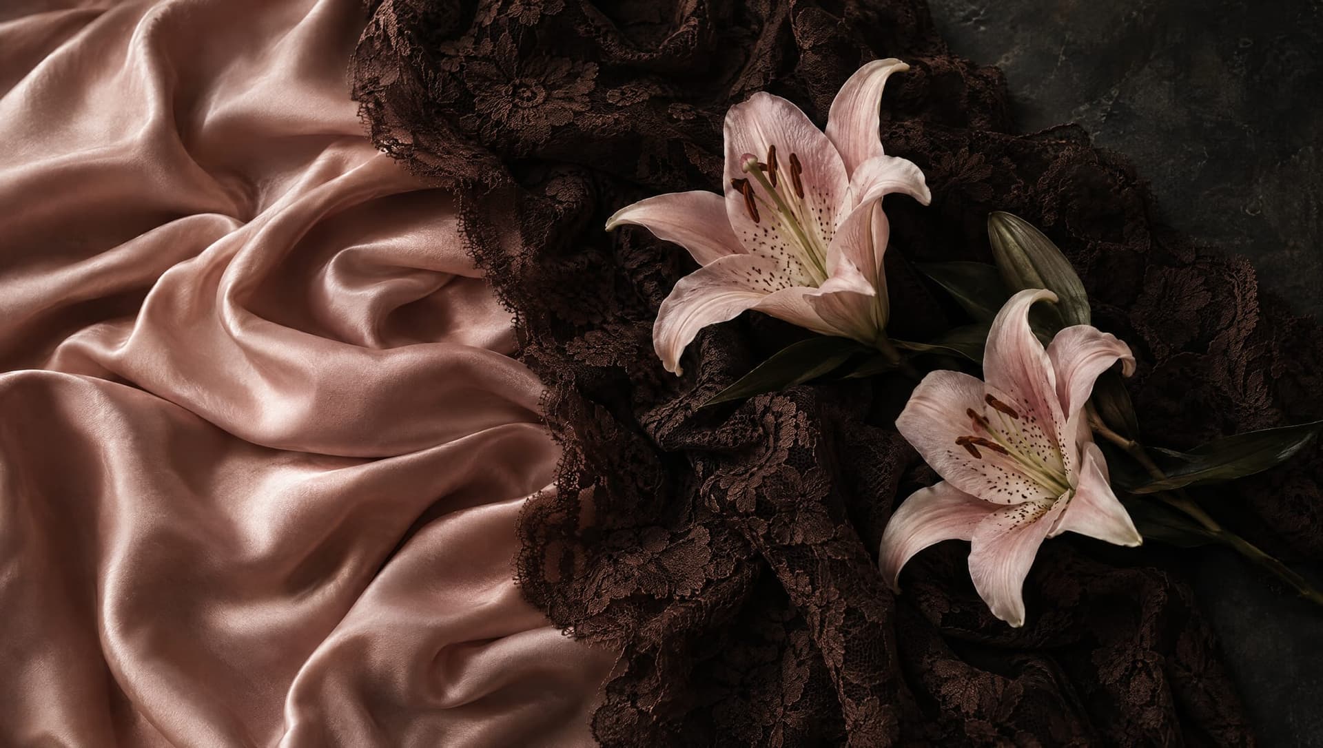 Two pink lilies on blush satin and espresso lace.